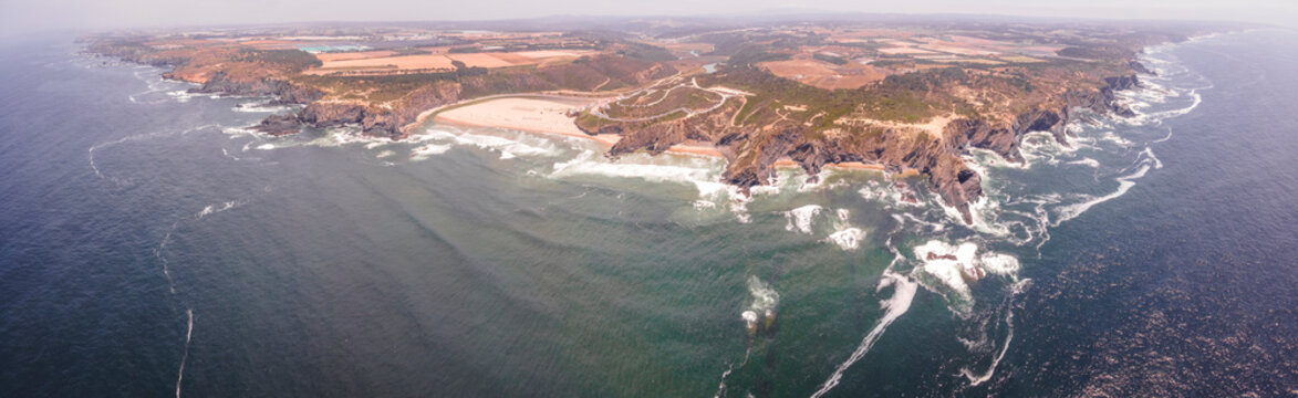 Panoramic aerial view of beautiful coastline with high cliffs along the Atlantic Ocean in Odeceixe, Faro district, Alentejo region, Portugal.