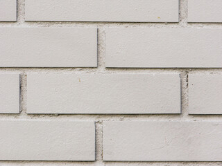 Abstract background of a gray brick wall close-up.