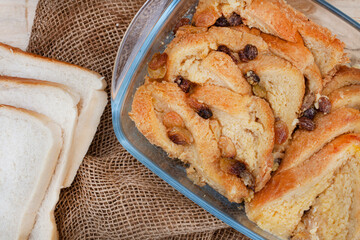 freshly baked classic bread and butter pudding with raisins on rustic surface