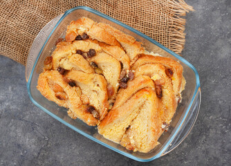 freshly baked classic bread and butter pudding with raisins on rustic surface