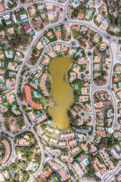 Aerial view of an exclusive luxury village with expensive villas and hotels on Troia Peninsula along the beach with artificial lake, Setubal, Portugal.