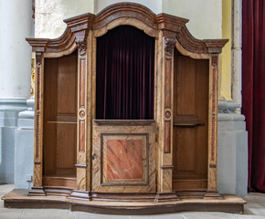 The historical confessional at baroque church.