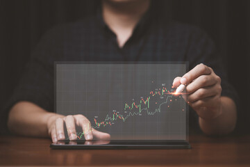 Businessman drawing virtual technical graph and chart for analysis stock market, technology investment and value investment concept.