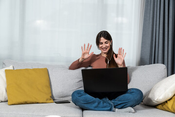 Young woman talking on video call with her psychotherapist doctor after online therapy sessions, happy that she is well and mentally health now after telemedicine conversations.