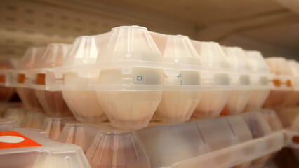 Close-up of a beautiful plastic packaging of fresh eggs on a store shelf