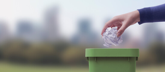 Woman putting paper in the waste bin