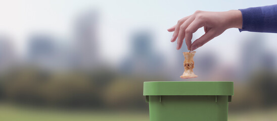 Woman putting organic waste in a bin