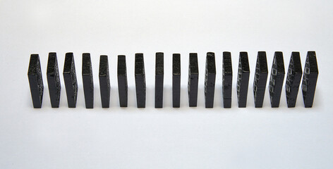 Black dominos in chain on white background