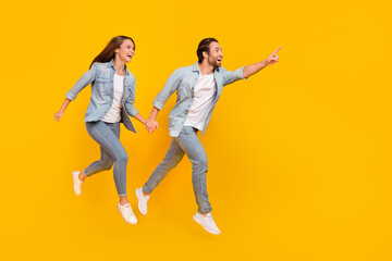 Full length body size view of beautiful handsome couple jumping showing copy space isolated over...