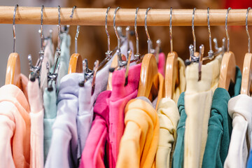 Hoodies hanging on rail in shop