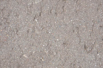 Background from old asphalt with potholes and splashes of light stones. Macro photo