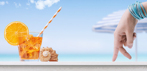 Woman having a refreshing cocktail at the beach