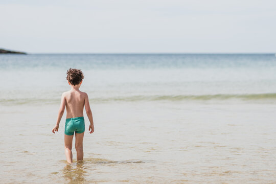 Unrecognizable boy standing towards sea