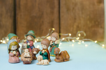 Close-up shot of mini colorful figures of the Nativity scene on a white table
