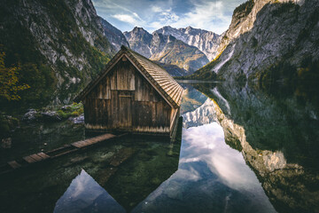 Landscape view of a wooden hut in the Obersee next to Koenigssee in Berchtesgaden, Bavaria, Germany