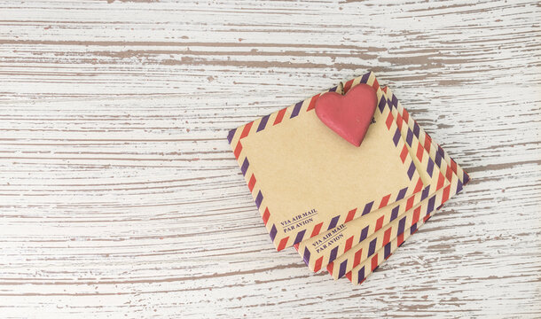 Stack of old letter with shape of love retro heart
