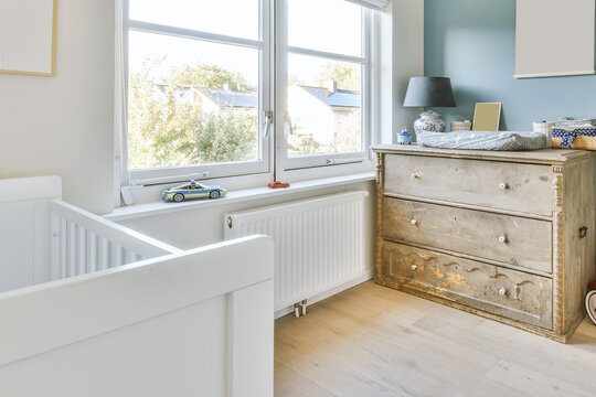 Crib and commode in bedroom