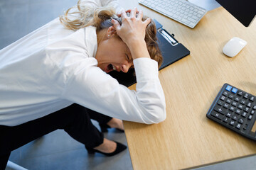 Depressed office worker holding her head and screaming, problems at work, to lose a job