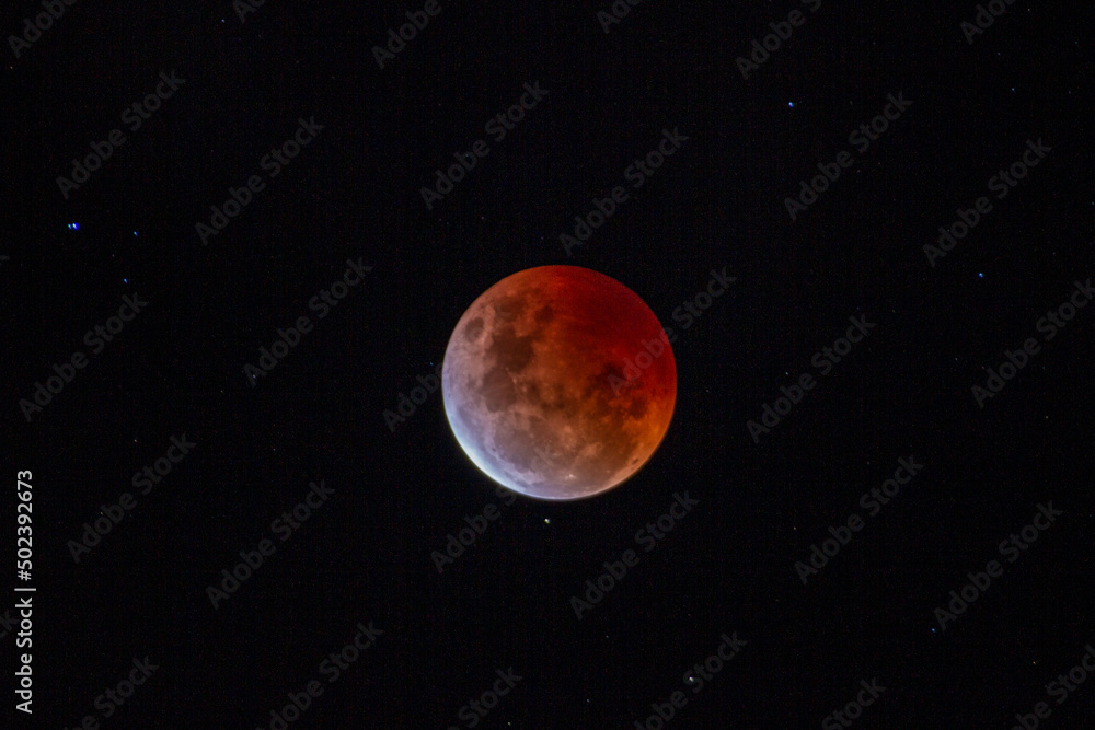 Poster magical view of a lunar eclipse with a starry sky
