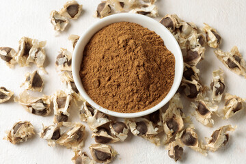 Brown seeds and moringa powder. Close-up, top view.