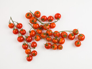 cherry tomatoes on a vine on white background