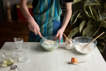 Faceless cook preparing batter for pancakes