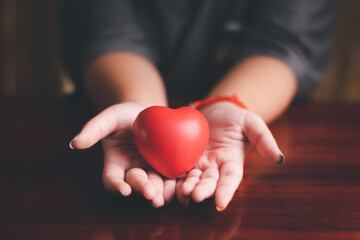 hands holding red heart, mental health and Life and health insurance,concept of love valentine, world heart day, foster care, gratitude, kind, thankful, hope, all lives matter concept