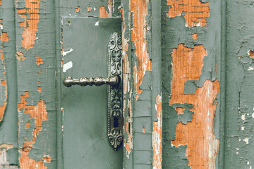 Closeup of an old and rustic knob on a wooden door