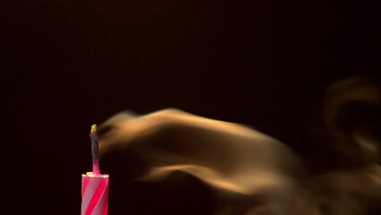 pink birthday candle being blown out extreme close up - 50fps