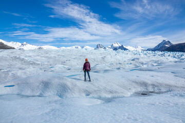 Fototapeta na wymiar Female traveler posing at the Perito Moreno Glacier in El Calafate, Argentina, Patagonia, South America
