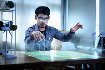 Energy engineer wearing AR headset or hologram glasses future, prototype design of wind turbine...