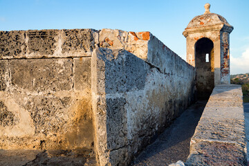 Light strikes an enclosed turret on the colonial wall in Cartagena, Colombia © Dandrewp/Wirestock Creators