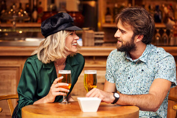 Caucasian couple having a drink at a bar.