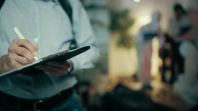 Close-up of detective filling out papers, forensic experts collecting evidence