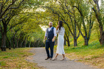 Fototapeta premium beautiful girl in a white dress and a guy in a fruit pair