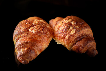 Delicious organic fresh homemade croissant on a dark background.