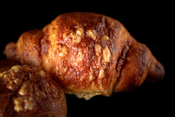 Delicious organic fresh homemade croissant on a dark background.