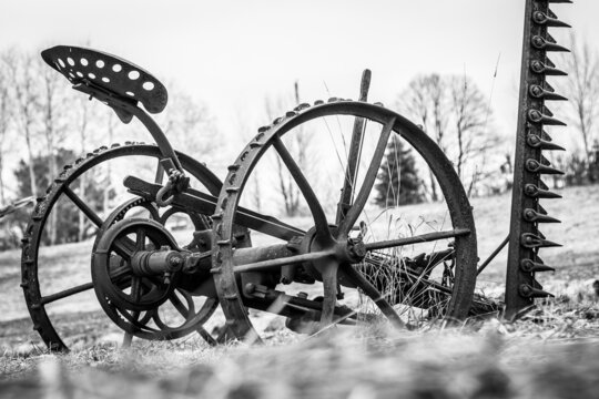 Grayscale shot of an old farm equipment