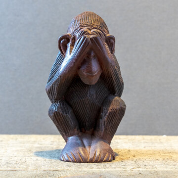 Closeup Of A Monkey Statue Covering Its Eyes