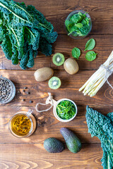 Healthy greens concept. Fresh kale, spinach, avocado, kiwi, seaweed, asparagus and green tea