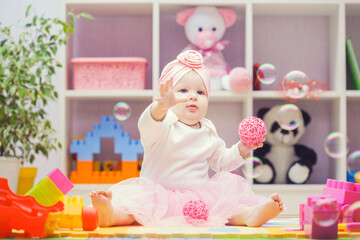 baby playing with colourful building blocks at home or kindergarten