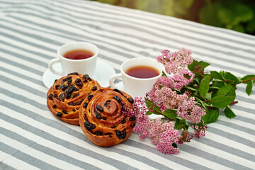 Sweet bun with glass of black tea on the table. white and green background. concept composition breakfast