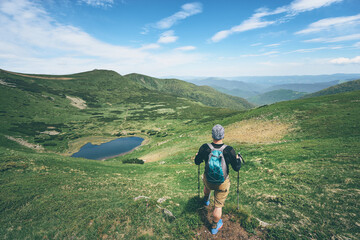 Obraz premium Active lifestyle. Traveling, hiking and trekking concept. Young man with backpack in the Carpathian mountains.