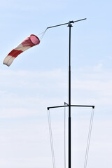 Vertical shot of a windsock against a blue sky