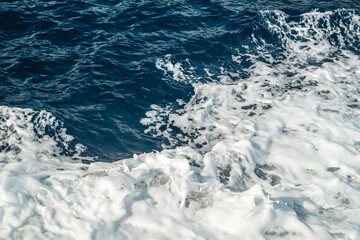 Fototapeta na wymiar Crashing waves foam in the mediterranean sea