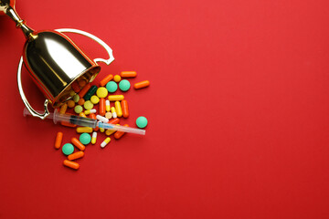 Flat lay composition with drugs on red background, space for text. Doping control