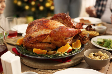 Festive dinner with baked turkey on table, closeup. Family Christmas celebration