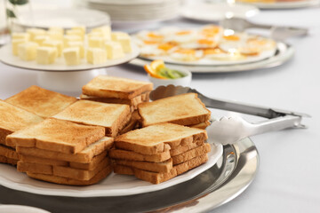 Different meals for breakfast on white table indoors. Buffet service