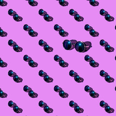 Creative pattern made of blue metal sunglasses on purple background. Vacation and travel concept