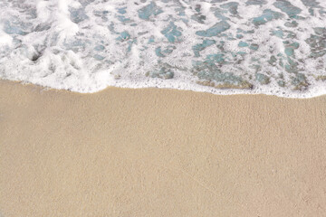 Fototapeta na wymiar Beautiful foamy sea tide on sandy beach